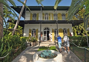 Visitors to the Ernest Hemingway Home & Museum stroll towards the entrance, shortly after a ceremony was staged designating the site a Literary Landmark. The designation was given by a division of the American Library Association. 